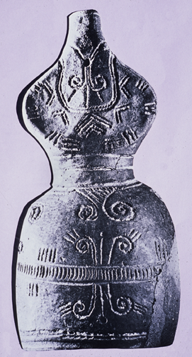 full-sized clay figurine with long skirt and incised patterns