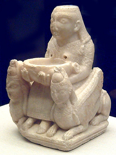 goddess holding bowl and seated between two sphinxes. she wears a pleated linen robe.