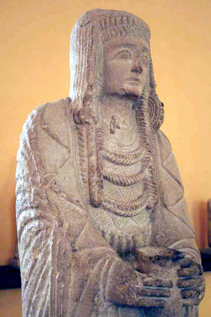 limestone statue of robed priestess holding libation cup