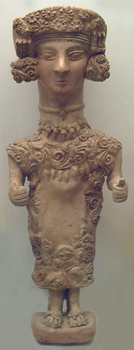 clay figure with elaborately decoated head and dress