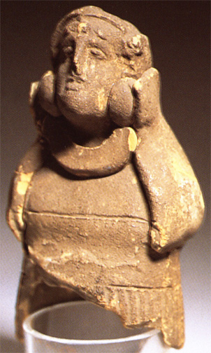 clay lady with large jaw and heavy necklace and earrings