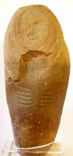 rounded stone pillar with headdress, necklace, and hands placed at center of body