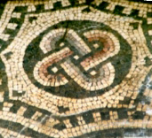 mosaic in green and cream of four-lobed knot pattern