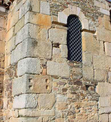 romanesque chapel showing cornerstone with four indentations made to mount goat statue