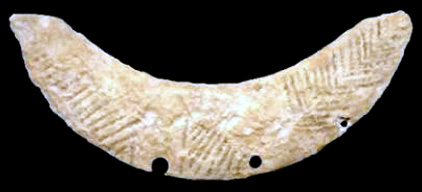 limestone crescent incised with line decoration