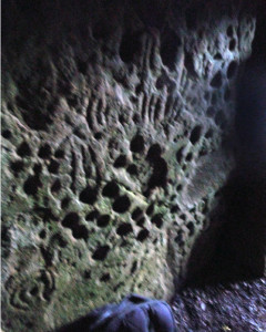 Stone honeycombed with deep cupmarks, Cairn T passageway