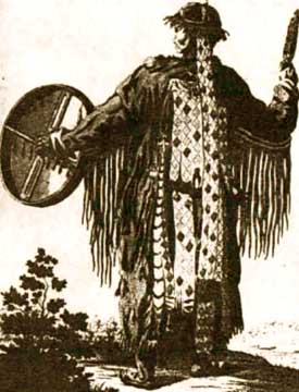 Siberian shaman drumming in ful regalia