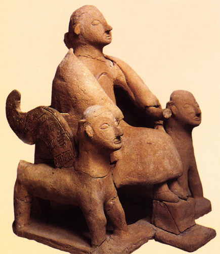 clay figure goddess between winged lions