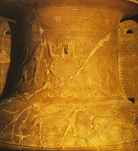 widebodied goddess with upraised arms, tightly hugged by two youths, and flanked by lions