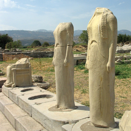 ruins of temple with seated goddess and two standing goddesses