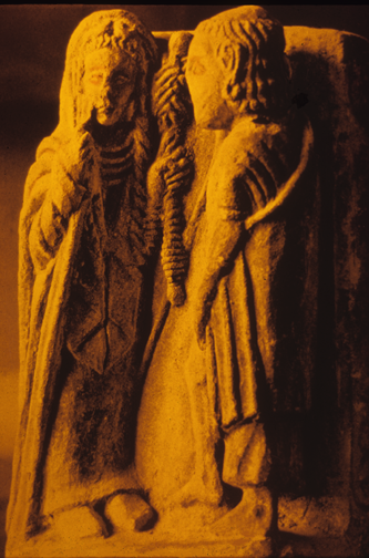 limestone sculpture of woman with distaff and man in cloak