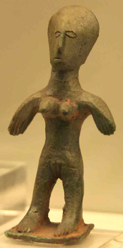 clay figurine of naked woman with slightly outstretched arms and robust physique