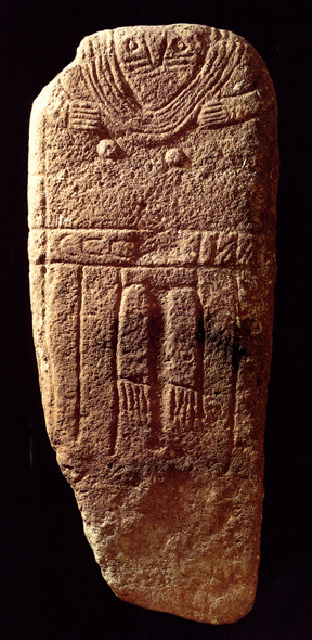 stone slab with abstract woman in heavy necklaces